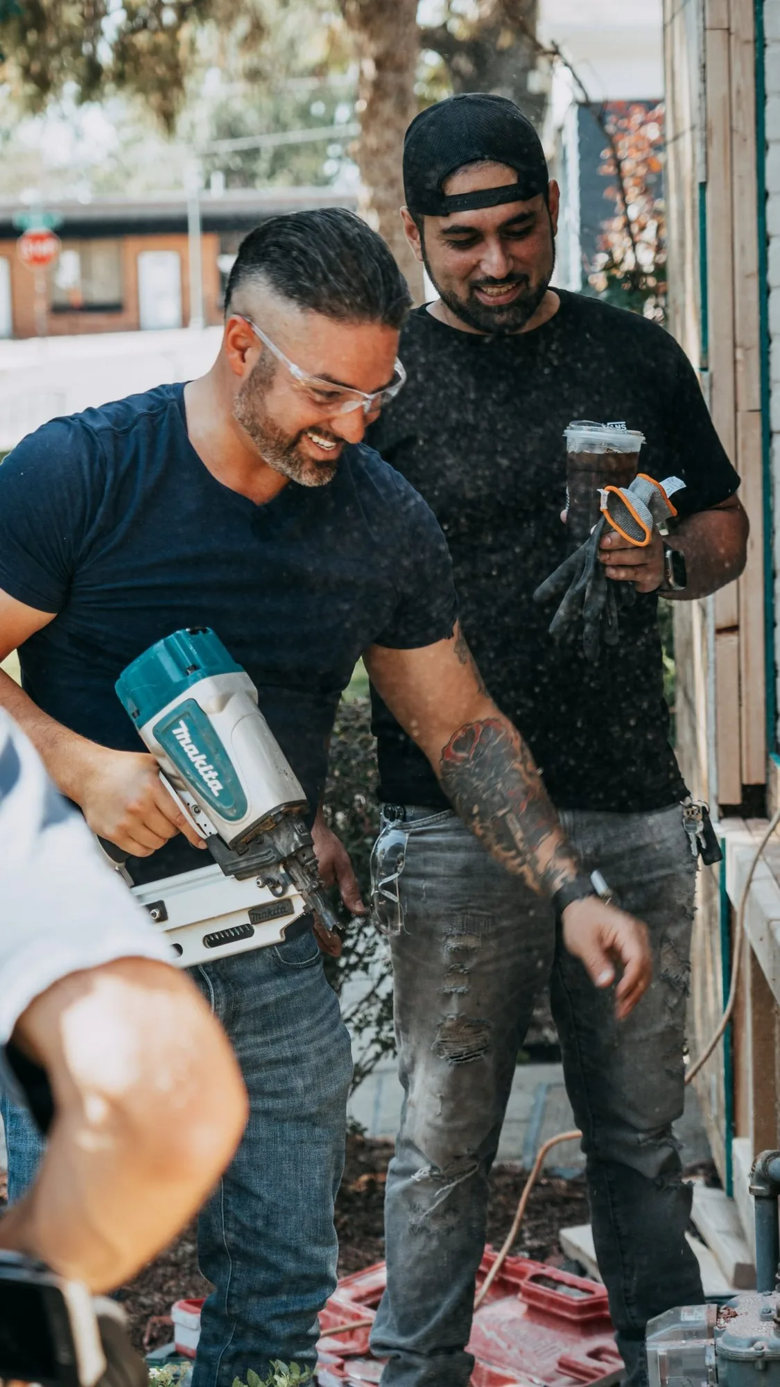 Rico Leon working with a framing nailer on a job site