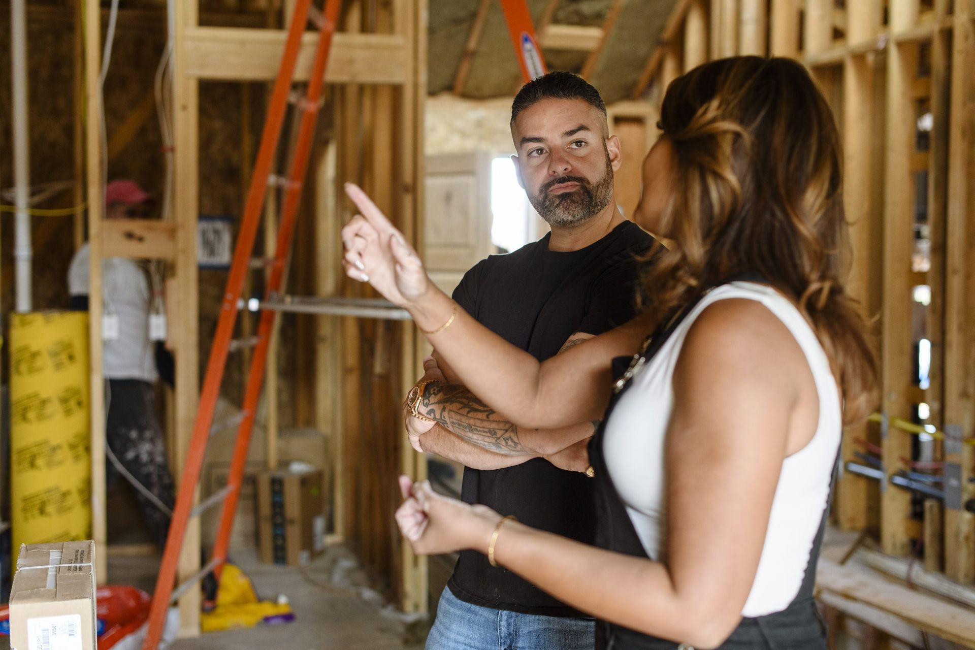 Rico Leon walking a client through a home under reconstruction