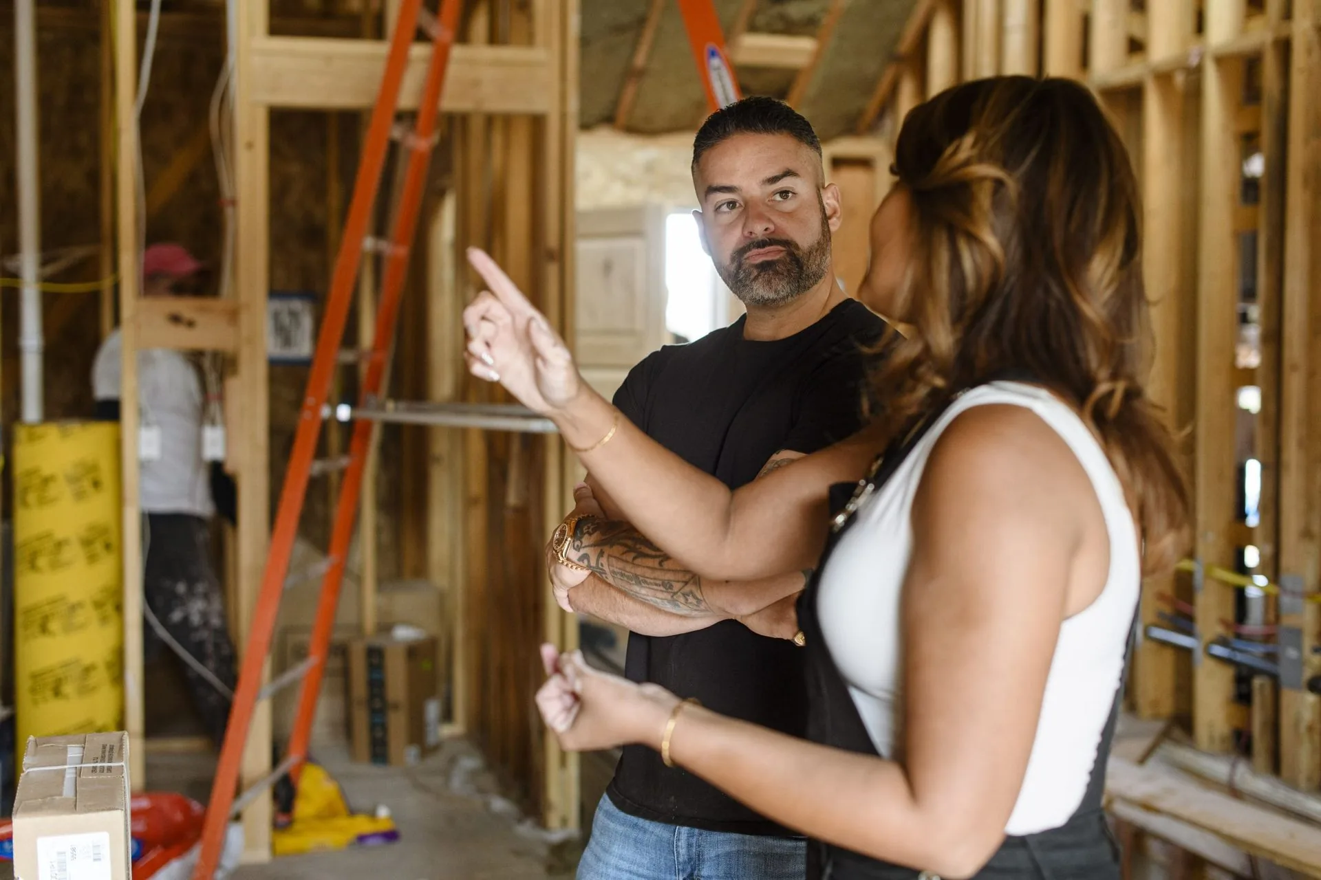 Rico Leon walking a client through a home under reconstruction